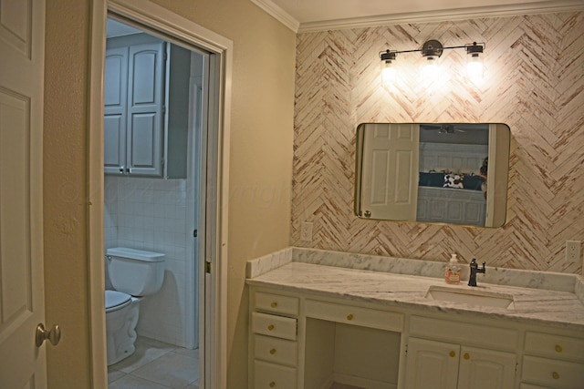 bathroom with toilet, vanity, and ornamental molding