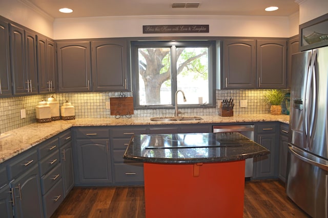 kitchen featuring dark wood-type flooring, light stone countertops, sink, and stainless steel appliances