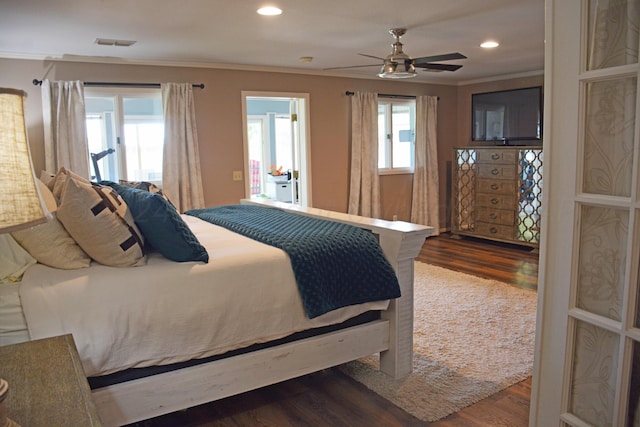 bedroom featuring ornamental molding, hardwood / wood-style flooring, and ceiling fan