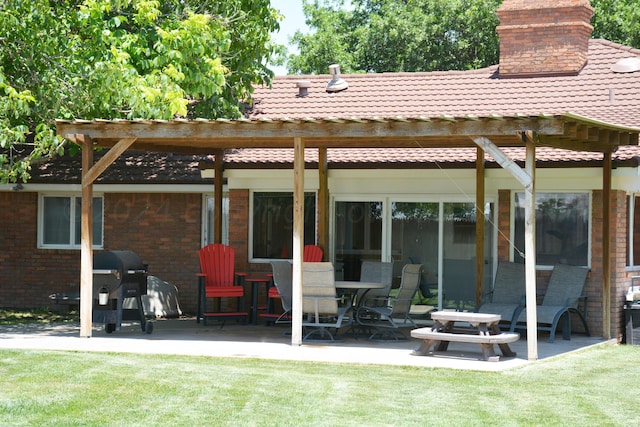 rear view of property featuring a patio and a yard