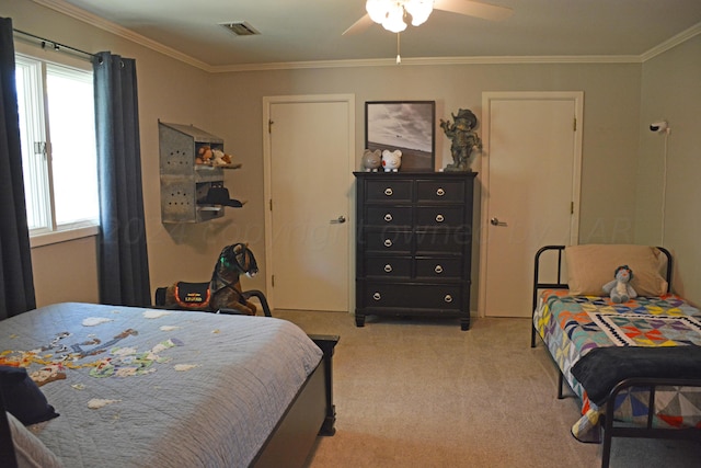 carpeted bedroom with ceiling fan, multiple windows, and ornamental molding