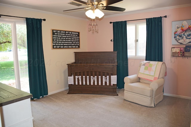 bedroom with multiple windows, carpet flooring, ceiling fan, and crown molding