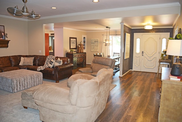 living room featuring a chandelier, dark hardwood / wood-style floors, and crown molding