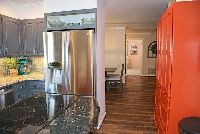 kitchen with stainless steel appliances, decorative backsplash, dark hardwood / wood-style floors, crown molding, and light stone countertops