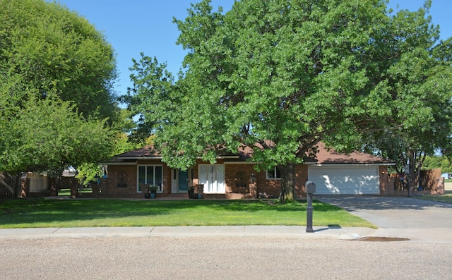 view of front of house with a garage and a front yard