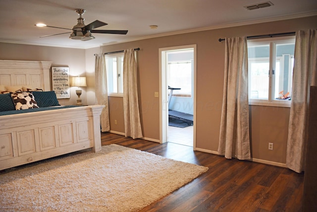 bedroom with dark wood-type flooring, ornamental molding, and ceiling fan