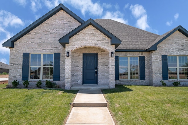 7602 Castleman Rd, Amarillo, TX 79119 - view of front of house with a front lawn, brick siding, and roof with shingles