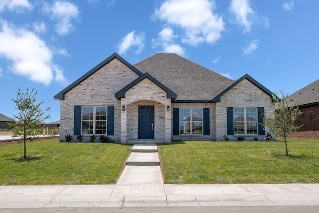 7602 Castleman Rd, Amarillo, TX 79119 - view of front of home featuring a front lawn, brick siding, and a shingled roof