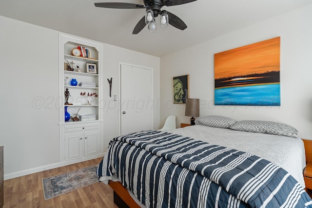 bedroom featuring baseboards, a ceiling fan, and wood finished floors