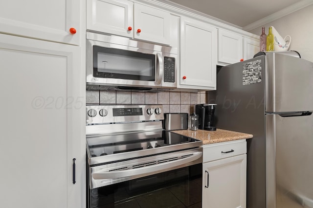 kitchen featuring white cabinets, appliances with stainless steel finishes, ornamental molding, light stone countertops, and backsplash