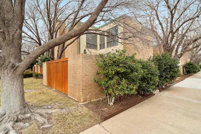 view of side of property featuring brick siding