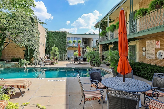 pool featuring outdoor dining space and a patio area