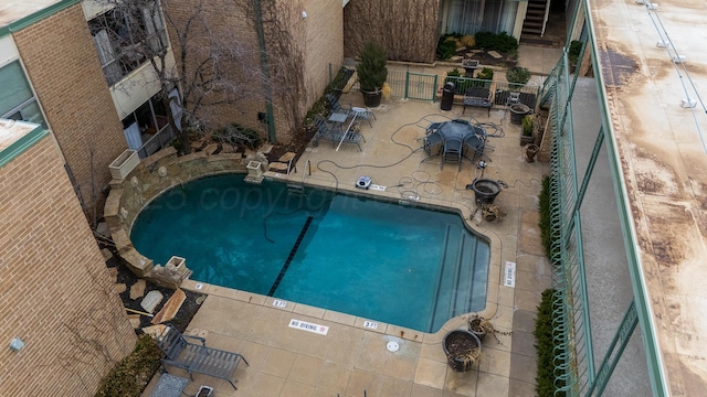 pool featuring a patio area and fence