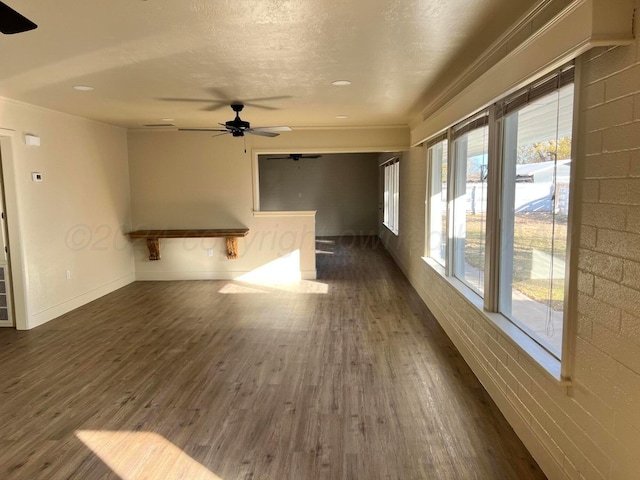 unfurnished room featuring dark hardwood / wood-style floors, ceiling fan, and crown molding