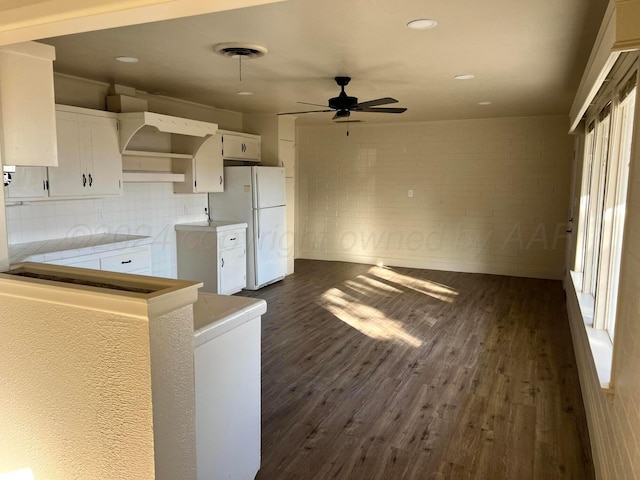 kitchen featuring white cabinetry, white fridge, dark wood-type flooring, and ceiling fan