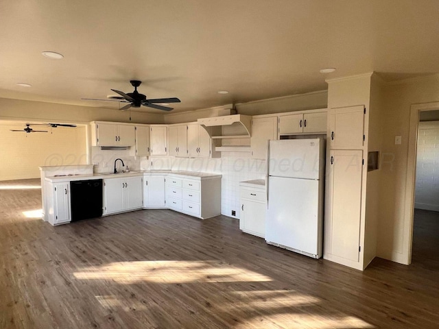 kitchen featuring dark wood-type flooring, sink, white refrigerator, white cabinets, and black dishwasher