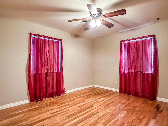 spare room with wood-type flooring and ceiling fan