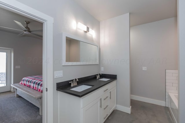 bathroom with a bathing tub, vanity, and ceiling fan