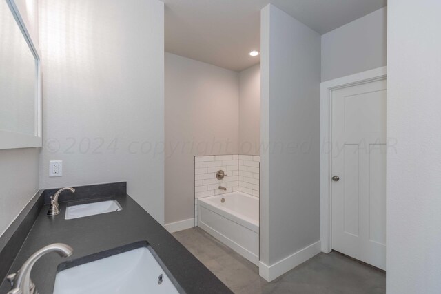 bathroom with a washtub and vanity