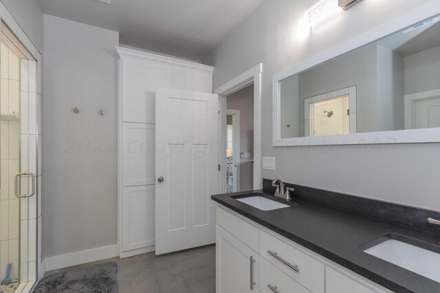 bathroom featuring concrete flooring, vanity, and an enclosed shower