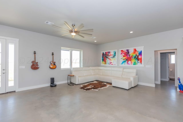 unfurnished living room with concrete floors and ceiling fan