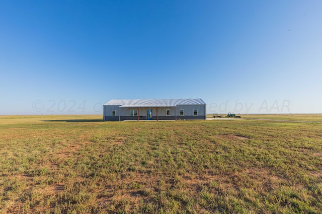 view of front facade with a rural view and a front yard