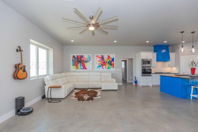 living room with concrete flooring and ceiling fan