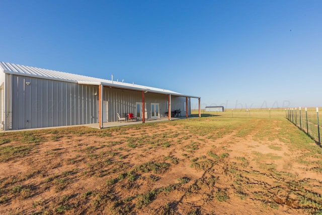 view of yard with an outbuilding and a rural view