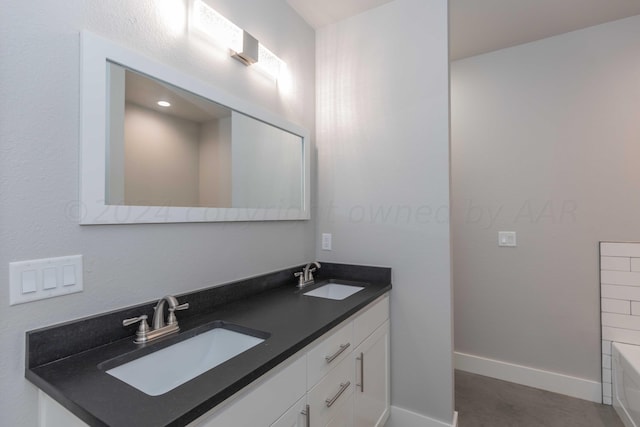 bathroom featuring a bath and vanity