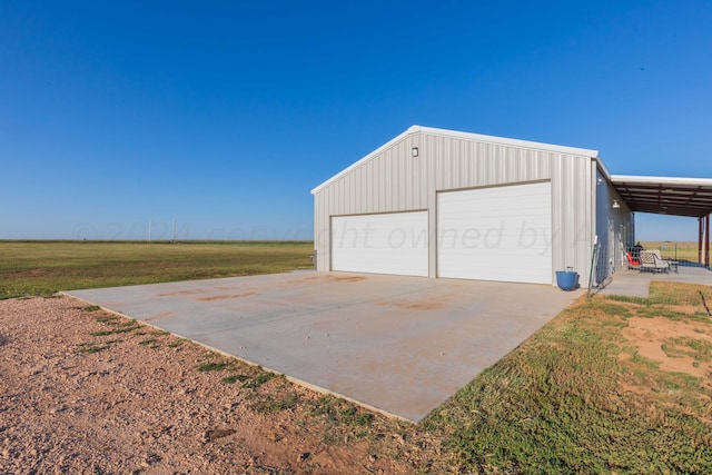 garage with a yard and a carport