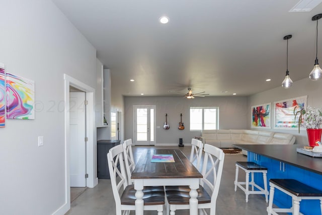 dining room featuring concrete flooring and ceiling fan