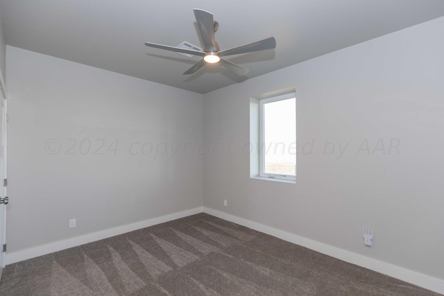 unfurnished room with ceiling fan and dark carpet