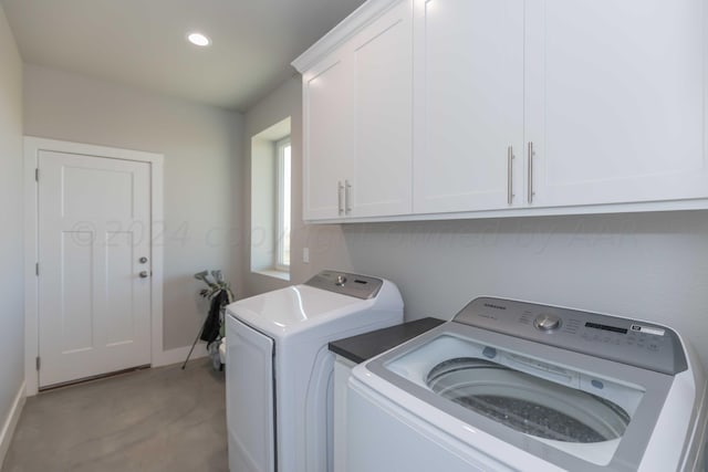 laundry room featuring cabinets and washing machine and clothes dryer