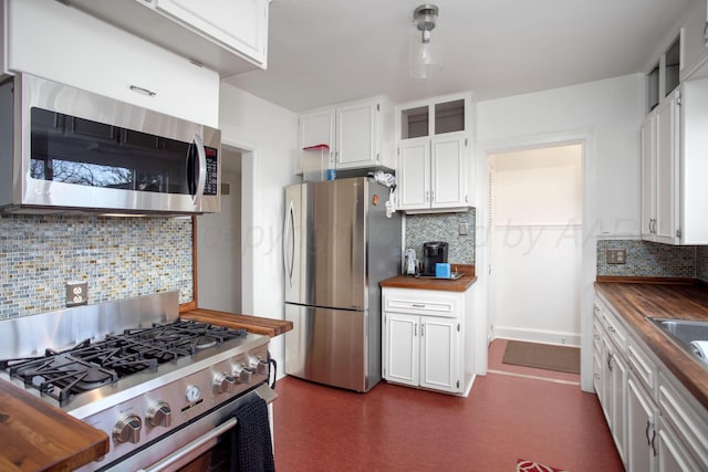 2402 S Hayden St, Amarillo, TX 79109 - kitchen featuring appliances with stainless steel finishes, butcher block countertops, decorative backsplash, and white cabinetry