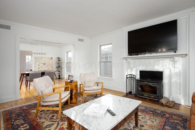 2402 S Hayden St, Amarillo, TX 79109 - living area with wood finished floors, crown molding, and a wood stove