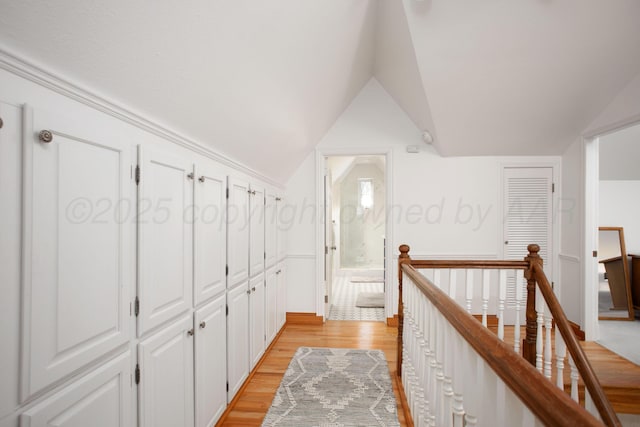 2402 S Hayden St, Amarillo, TX 79109 - hall with an upstairs landing, light wood-style flooring, and vaulted ceiling