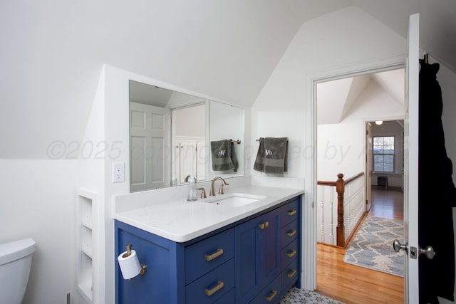 2402 S Hayden St, Amarillo, TX 79109 - bathroom with vaulted ceiling, vanity, and wood finished floors