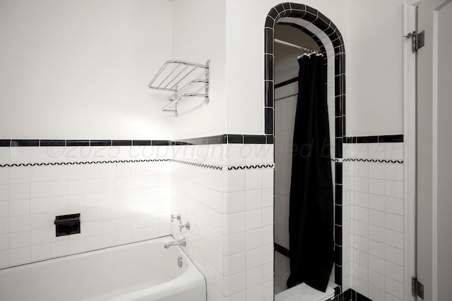 2402 S Hayden St, Amarillo, TX 79109 - bathroom with tiled shower, wainscoting, tile walls, and a tub to relax in
