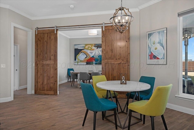 dining room with a barn door, baseboards, a chandelier, and wood finished floors