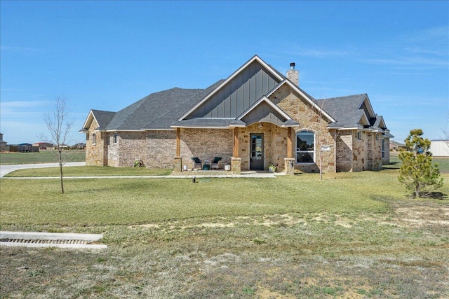 view of front of home featuring board and batten siding, a chimney, and a front lawn