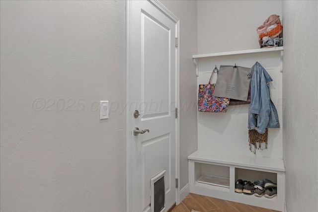 mudroom featuring visible vents, baseboards, and wood finished floors