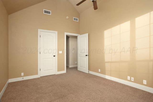 unfurnished bedroom featuring visible vents, baseboards, high vaulted ceiling, and carpet floors