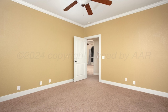 spare room featuring crown molding, ceiling fan, light colored carpet, and baseboards