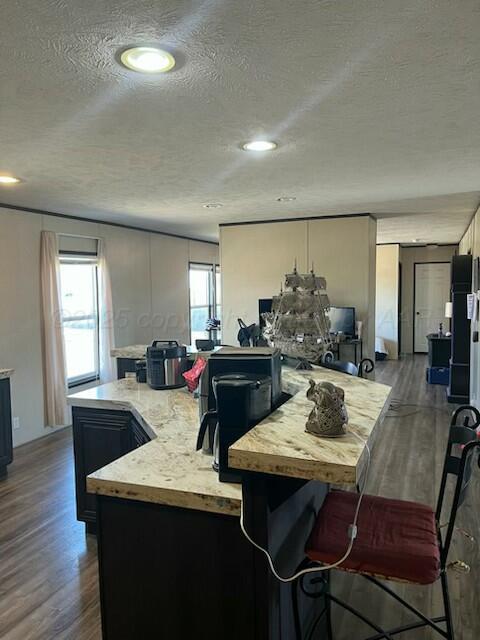 kitchen with hardwood / wood-style flooring and a textured ceiling