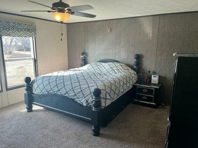 bedroom featuring ceiling fan and carpet