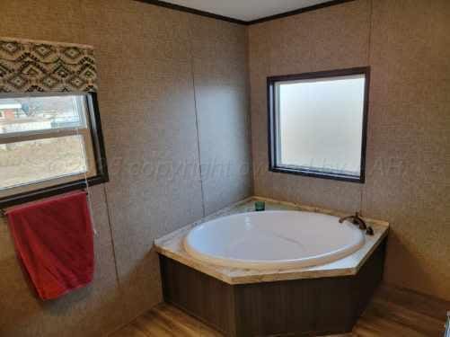 bathroom featuring a tub, plenty of natural light, and hardwood / wood-style floors