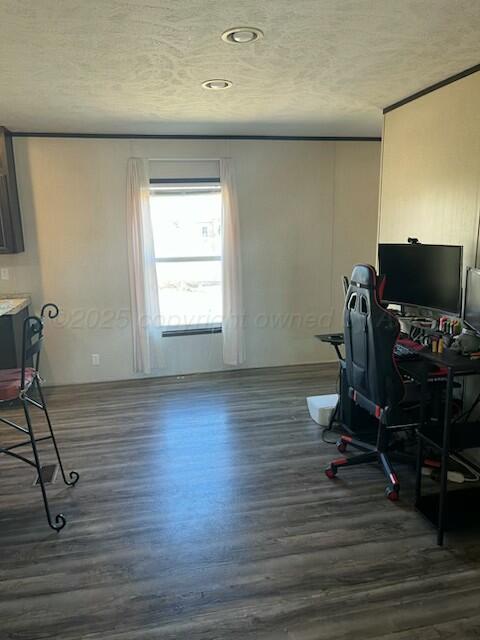 office area featuring dark wood-type flooring and a textured ceiling