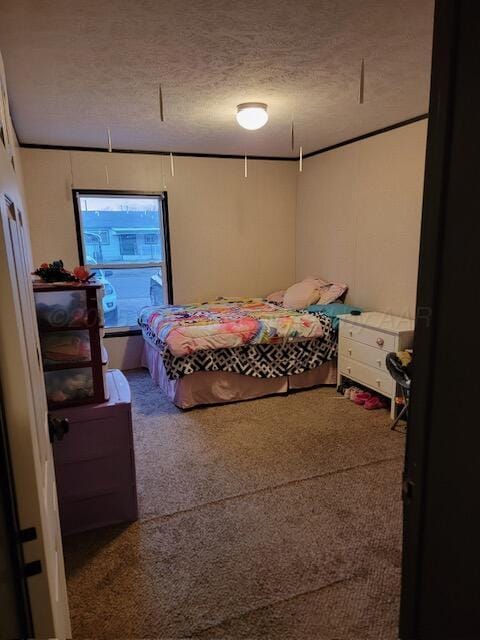 bedroom with carpet flooring and a textured ceiling