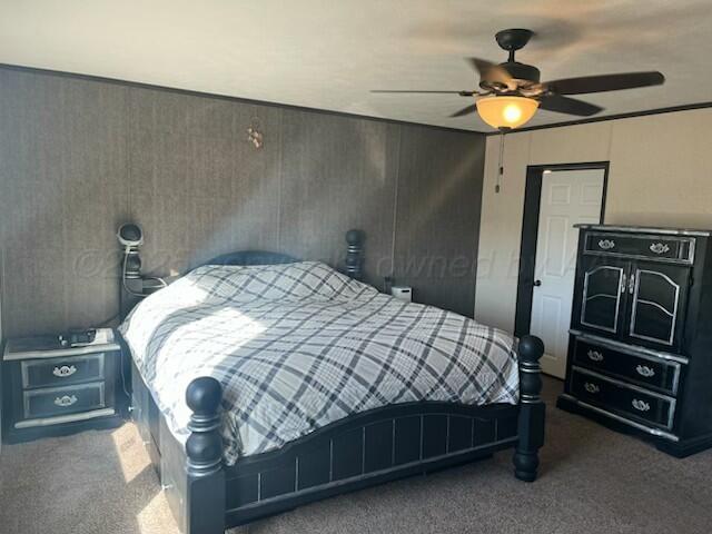 bedroom featuring dark carpet and ceiling fan