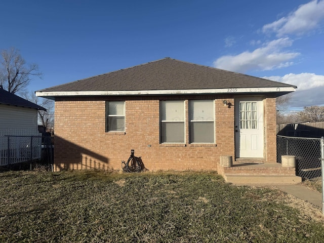 rear view of house with a lawn